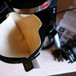 Using a paper filter in a drip filter coffee machine stops natural oils and sediment getting to the cup