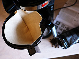 Using a paper filter in a drip filter coffee machine stops natural oils and sediment getting to the cup